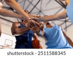 Basketball team huddling together, showing unity and teamwork in gym. sports, athletes, motivation, competition, huddle