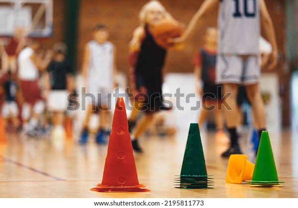  Basketball training session for\
youth. School sports class. Junior level basketball player bouncing\
basketball. Young basketball player with classic\
ball