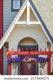 Baskets Of Hanging Colorful Flowers On Entrance Gate Of House. Summer Flowers In Ornamental Plant. Street Photo, Nobody, Selective Focus