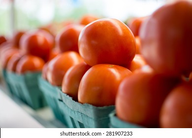 Baskets of tomatoes all in a row at the local farmer's market. - Shutterstock ID 281907233
