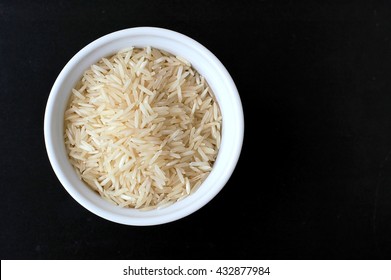 Basmati Rice In The Bowl On The Black Background, Overhead Horizontal View