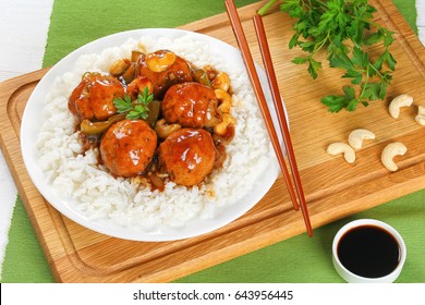 Basmati Rice With Turkey Meatballs Stewed With Green Bell Pepper, Onion, Soy Sauce, Chinese Cooking Wine And Spices On Plate On Wooden  Board With Chopsticks, View From Above, Close-up