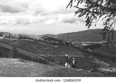 BASQUE COUNTRY - AVRIL 26, 2018: Senior Couple Hiking At Mountains In Spring In Basque Country At Border Between France And Spain. Black And White Photo.