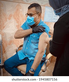 Basra, Iraq - March 28, 2021: Photo Of Man Taking AstraZeneca Vaccine Against Covid19 In Hospital In Basra City