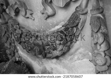 bas-relief, fragment, floral motif. old art bas-relief wall. detail of a sandstone, flower relief.Bas-relief with floral ornament on the gray stone wall, background. Toned  Decoration item.