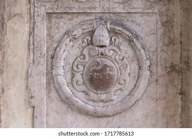 Bas-relief On One Of The Walls Of Cracow. Old Coat Of Arms With A Lion And A Papal Tiara.