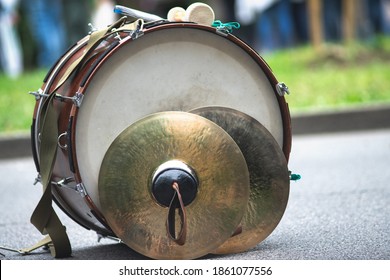 A bass drum with fanfare cymbals resting on the ground - Shutterstock ID 1861077556