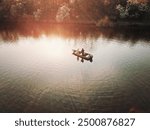 Bass fisherman fishing out of bass boat on fall afternoon. Drone photo taken from above.