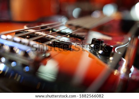 bass guitar photographed on stage in bright spotlights