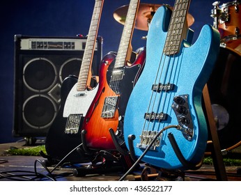 Bass guitar, rhythm guitar, lead guitar stand on stage before the concert.