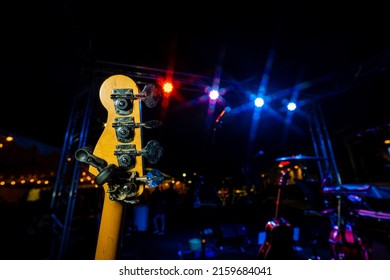 Bass Guitar Worm Gear Headstock Turning Pins at Live Outdoor Music Show at Night Yellow Cool Blue Lights Nightlife
