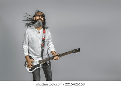 Bass Player With Beard And Long Hair. Studio Shot