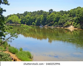 Bass River Estuary With Reflections In The Water Separates The Towns Of Yarmouth And Dennis On The Bass River In Cape Cod,Massachusetts. Near The Cape Cod Rail Trail Bicycle Bridge.