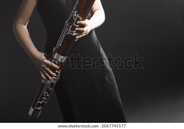 Bassoon woodwind instrument with\
player hands. Orchestra musical instruments close\
up