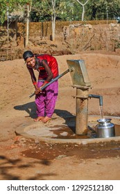  Bastar, December ,21,2011 : Young Tribal Girl  Fetching Drinking  Water From State Sponsored  Bore Well, Tube Well  Water  Hand Pump In Bastar, Chhattisgarh, India.Asia