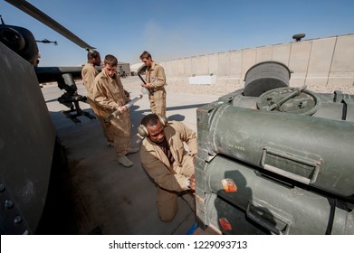 Bastion,Helmend /Afghanistan -Circa 2010
Army Air Corp Ground Crew Re-arm A AH 64 Longbow Apache Attack Helicopter  British Army Air Corp  During Operation Herrick 