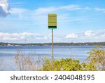 Bat box on pole in front of lake