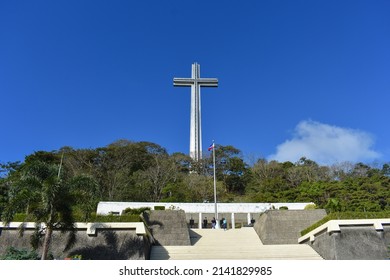 Bataan, Philippines - January 19 2019: Facade of Mount Samat National Shrine or Shrine of Valor in Bataan, Philippines showing the high cross on top of the mountain visited by tourists on a sunny day.