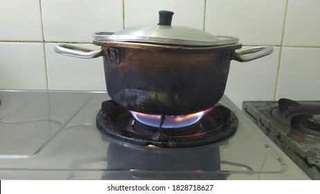 Batam Island Indonesia, October 7,2020: Boiling water on a stove and a scorched pot in Taman Raya, Batam Island, Indonesia. - Shutterstock ID 1828718627