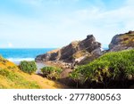 Batanes, Philippines: High angle view of rugged cliffs and coastal hills overlooking deep blue Pacific Ocean at Valugan Boulder Beach.
