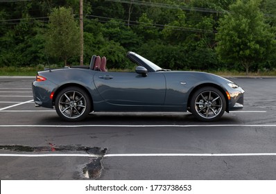 Batavia, Oh/USA. June 21, 2020. Mazda Miata MX5 sitting alone in a parking lot during the late evening sunlight.