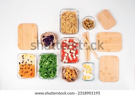 Batch cooking. Lunch box. Preparing meals for the week. Salad buffet. Balanced meal. Healthy food. Zero waste. Trendy meal. Carrots, dried mango, arugula, endive, olives, cheese, tomato,  cranberries.
