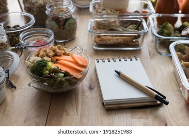 Batch cooking scene with an empty spiral menu notebook. - Shutterstock ID 1918251983