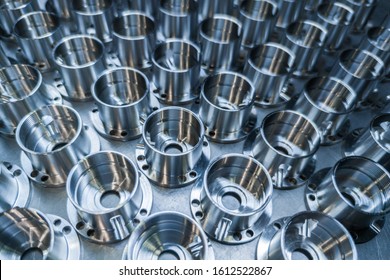a batch of shiny metal cnc aerospace parts production - close-up with selective focus for industrial background