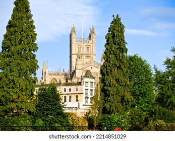 Bath Abbey Between Tall Green Trees In Natural Urban Landscape, United Kingdom