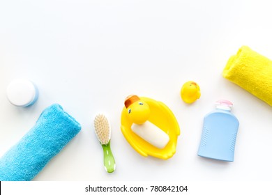 Bath Accessories For Kids. Yellow Rubber Duck, Soap, Sponge, Brushes, Towel On White Background Top View Copyspace