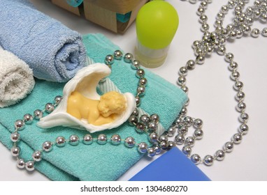 Bath Composition With Beautiful Cute Handmade Soap Angel In Wings On A Folded Towel And A Background Of Rolled Up Towels On A Light Background, Side View