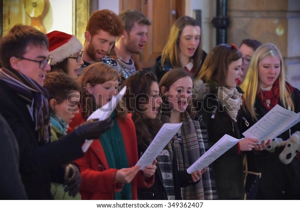 BATH - DEC 9: People sing carols at the Christmas\
Market in the streets surrounding Bath Abbey on Dec 9, 2015 in\
Bath, UK. The market is held annually in the historic Unesco World\
Heritage City.