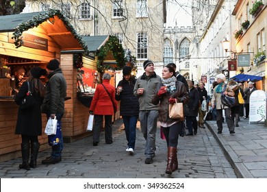 BATH - DEC 9: People Visit The Christmas Market In The Streets Surrounding Bath Abbey On Dec 9, 2015 In Bath, UK. The Landmark Somerset City Is Home To Many Local And International Stores And Shops.