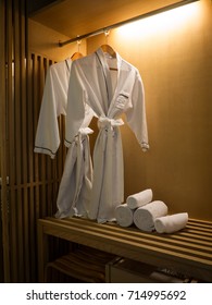 bath robe hanging in closet in front of bathroom.
