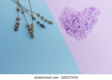 Bath Salts In The Shape Of A Heart On A Blue - Purple Background. Lavender Flowers. Spa Treatments. Place Text.