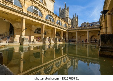 BATH, SOMERSET, UK - SEPTEMBER 15, 2019: Roman Baths at Bath Spa, Somerset. The Great Bath and view towards Bath Abbey and reflections in the pool. It is a UNESCO World Heritage Site.