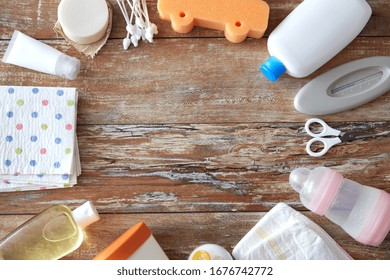 Bath Time And Care Products Concept - Baby Accessories For Bathing On Wooden Table At Home