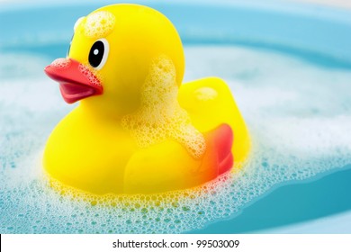 Bath time and rubber duck in soap foam
