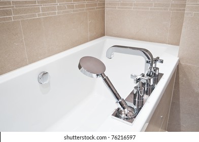 bath tub with modern fixtures and shower attachment