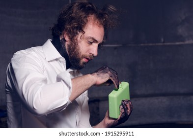 Bath, Uk, 02.02.2020 A Car Mechanic With Oil Spill All Over His Hands. Dirty Car Mechanic Car Garage. Car Oil Change And Maintenance. Scruffy Mechanics With Clean White Shirt.