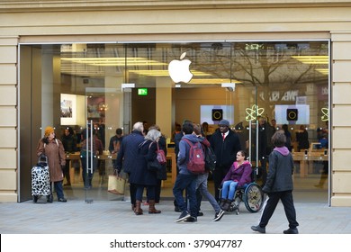 BATH, UK - FEB 10, 2016: People walk past an Apple store on a city centre street. The smartphone and consumer electronics giant has sold an estimated 250 million iPhone units worldwide.