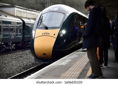 Bath, UK - March 7, 2019: A British Rail Class 800 Train Arrives At Bath Spa Railway Station As Passengers Wait On A Platform.