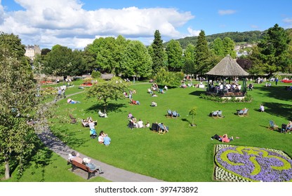 Bath, UK - September 12, 2010: Tourists and locals enjoy a sunny day in Parade Gardens. The Somerset city of Bath has UNESCO World Heritage status and receives over 4 million visitors each year.