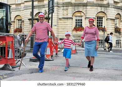 Bath, UK - September 28, 2012: A Family Dress Up As The Character Wally From The British Puzzle Book Where's Wally By Author And Illustrator Martin Handford. Wally Is Know As Waldo In The US Market.