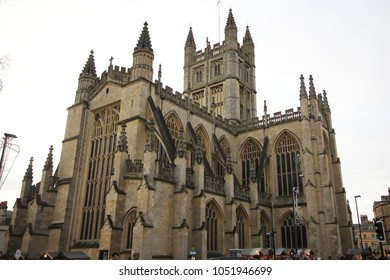 Bath, United Kingdom - December 6, 2013: Street view with The Abbey Church of Saint Peter and Saint Paul, Bath, commonly known as Bath Abbey. Ordinary people walk on city square.