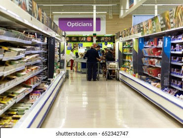 BATHGATE, SCOTLAND, UK - MAY 22, 2017. Tesco Supermarket Shopping Aisle. Optician Queue Visible At Back Of Shot.