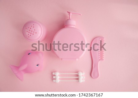 Chiэldren’s bathing accessories on a pink background. Hygiene products (cotton buds, shower gel,comb, Towel ). Cosmetic for girls. Natural organic cosmetics SPA branding mockups.