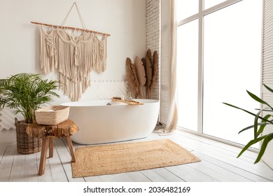 Bathing Room Interior Design. Cozy Empty Modern Bathroom Background With White Bathtub And Panoramic Windows, Rustic Decorations And Green Plants Indoors - Powered by Shutterstock