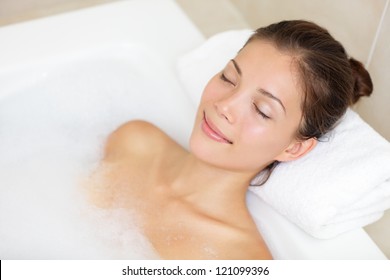 Bathing woman relaxing in bath smiling relaxing with eyes closed. Multicultural Asian / Caucasian young woman in bathtub. - Powered by Shutterstock