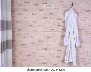 Bathrobe Hanging On Brick Wall